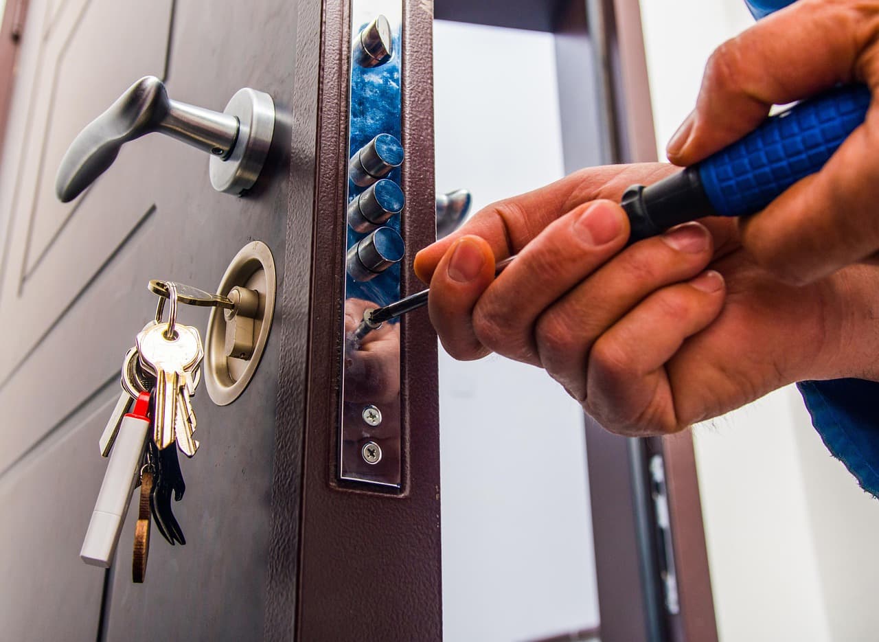 A person unlocking a house door